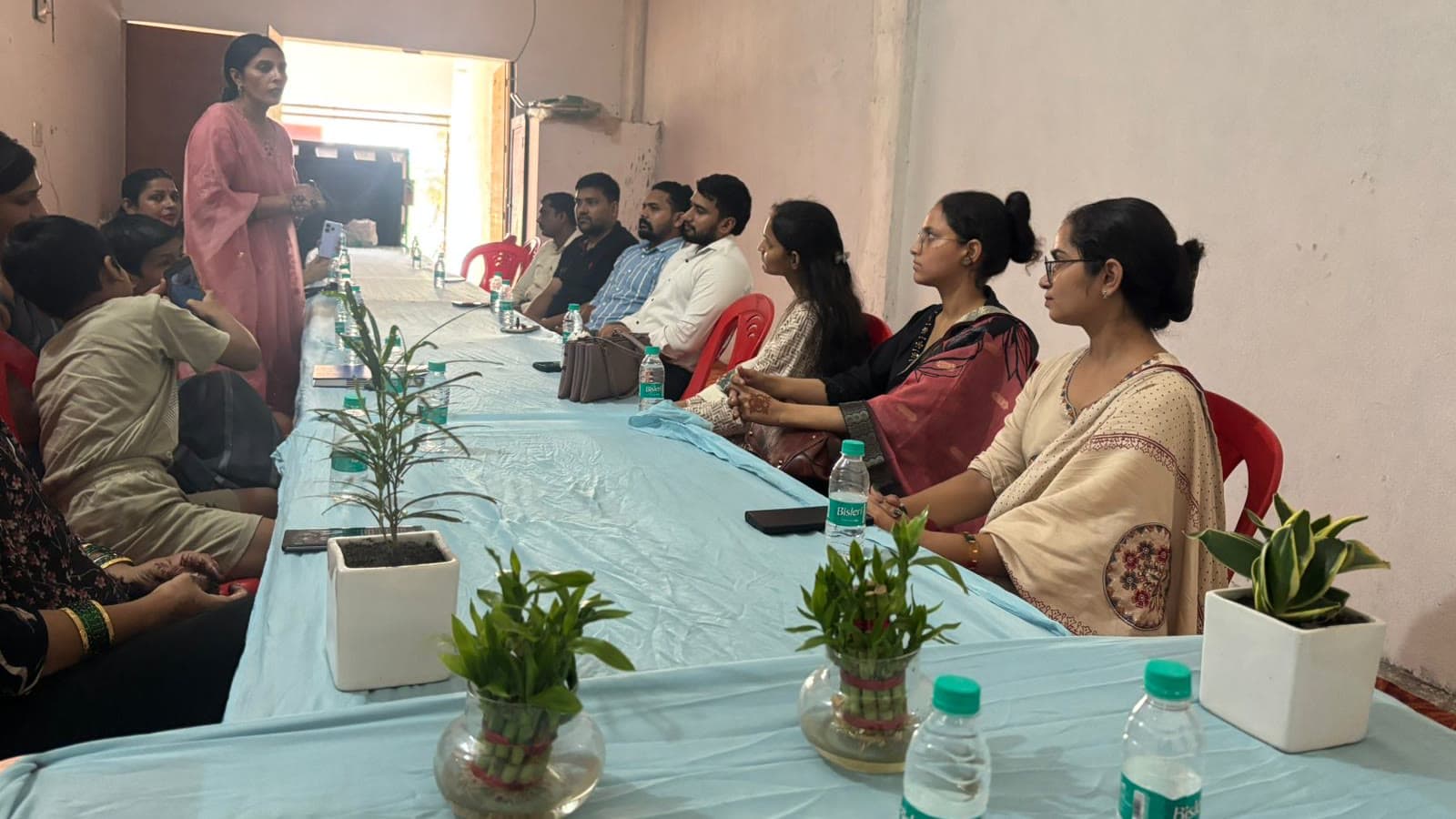 Women seated around the table at a Dreamwings community meeting